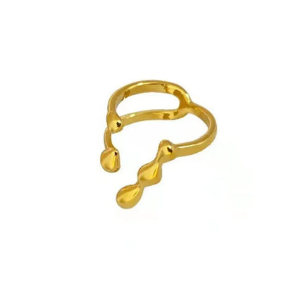 Gold and silver adjustable brass ring featuring a large spherical design on an open shank.