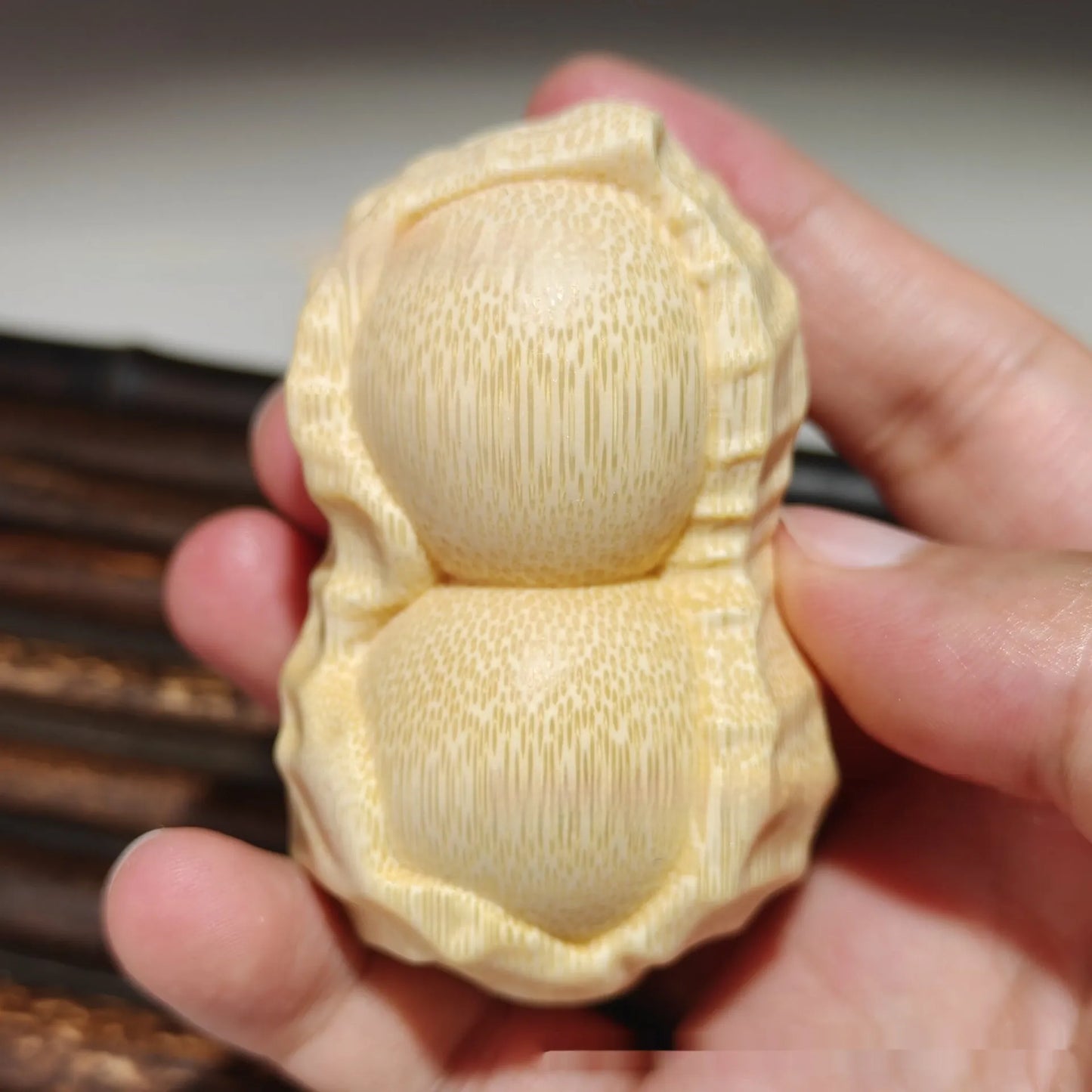 Hand-carved solid bamboo peanut ornament with modern design for gifting and decor