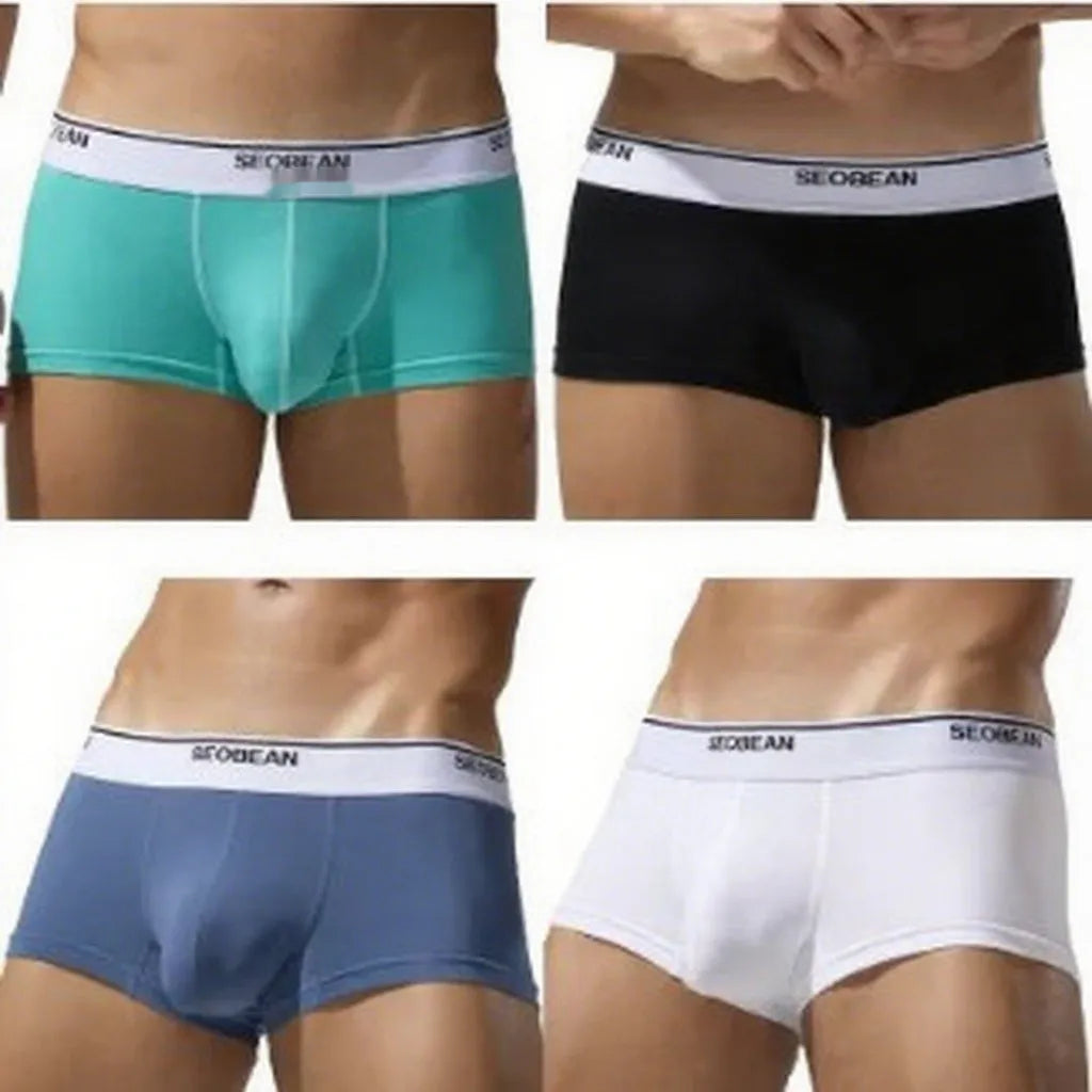 Men's solid colour cotton low waist boxers in white, blue grey, cyan, and black on a size label.