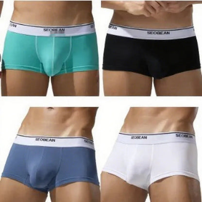 Men's solid colour cotton low waist boxers in white, blue grey, cyan, and black on a size label.