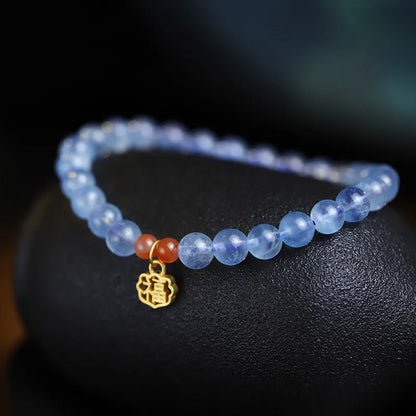 Ice translucent aquamarine crystal bracelet with 8mm round beads and sequin details on a wrist.