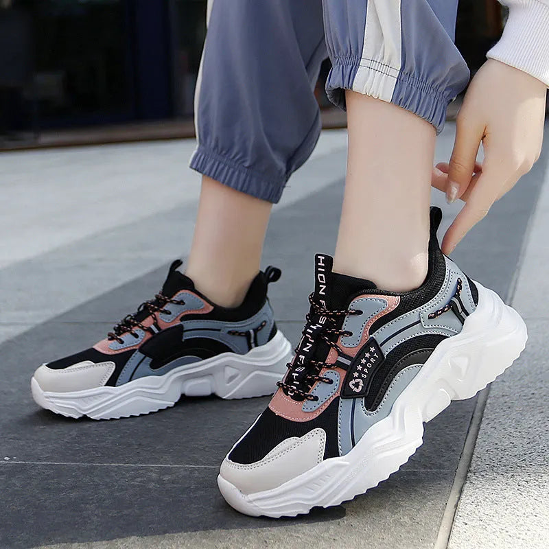 Women's white casual sports shoes with mesh upper, thick sole, buckle strap, and round toe.