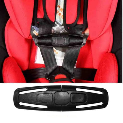 Black nylon child safety seat harness buckle clip, shown next to a 5-point harness chest plate.