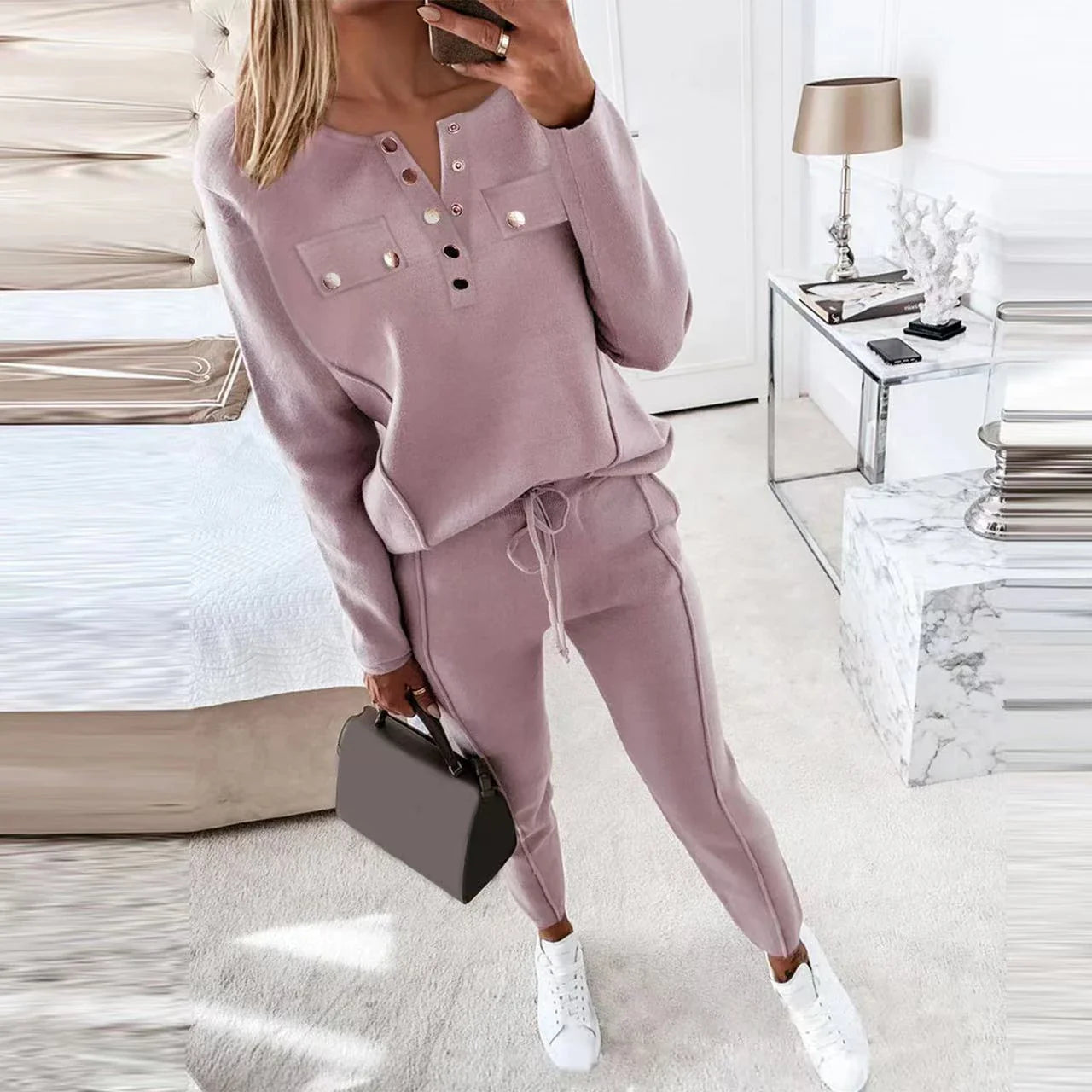 Cozy two-piece loungewear set with crew-neck sweater top and drawstring pants in pink, grey, and navy blue colors