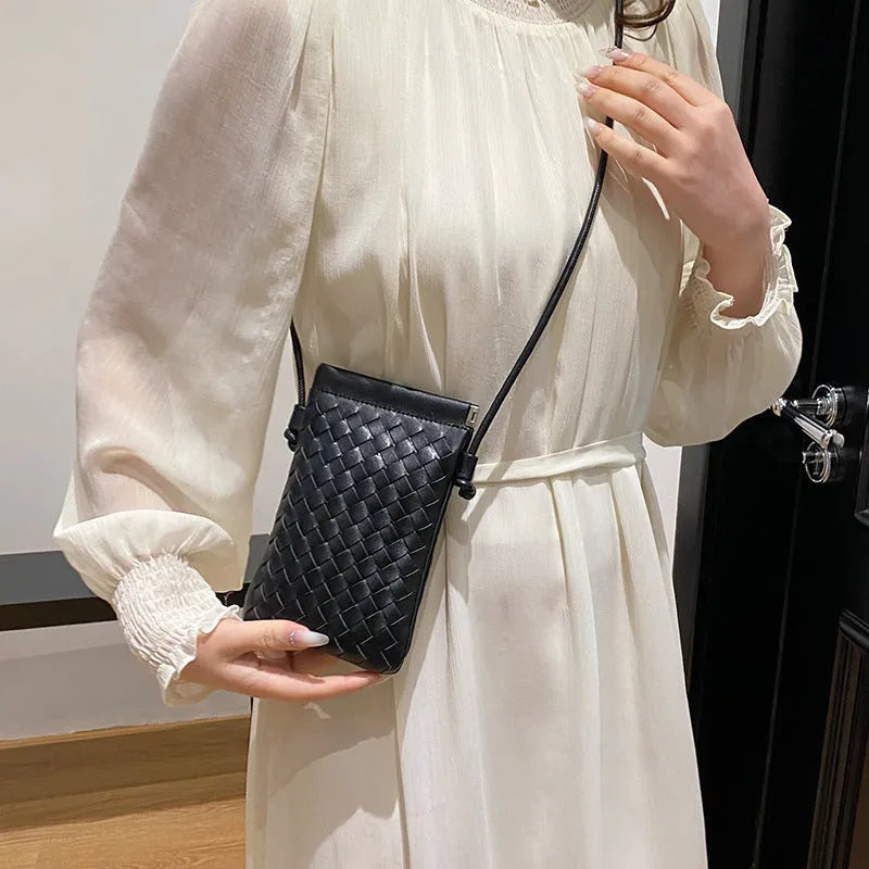 Vertical square vintage weave crossbody bag in multiple colours showing internal dark cell phone pocket.