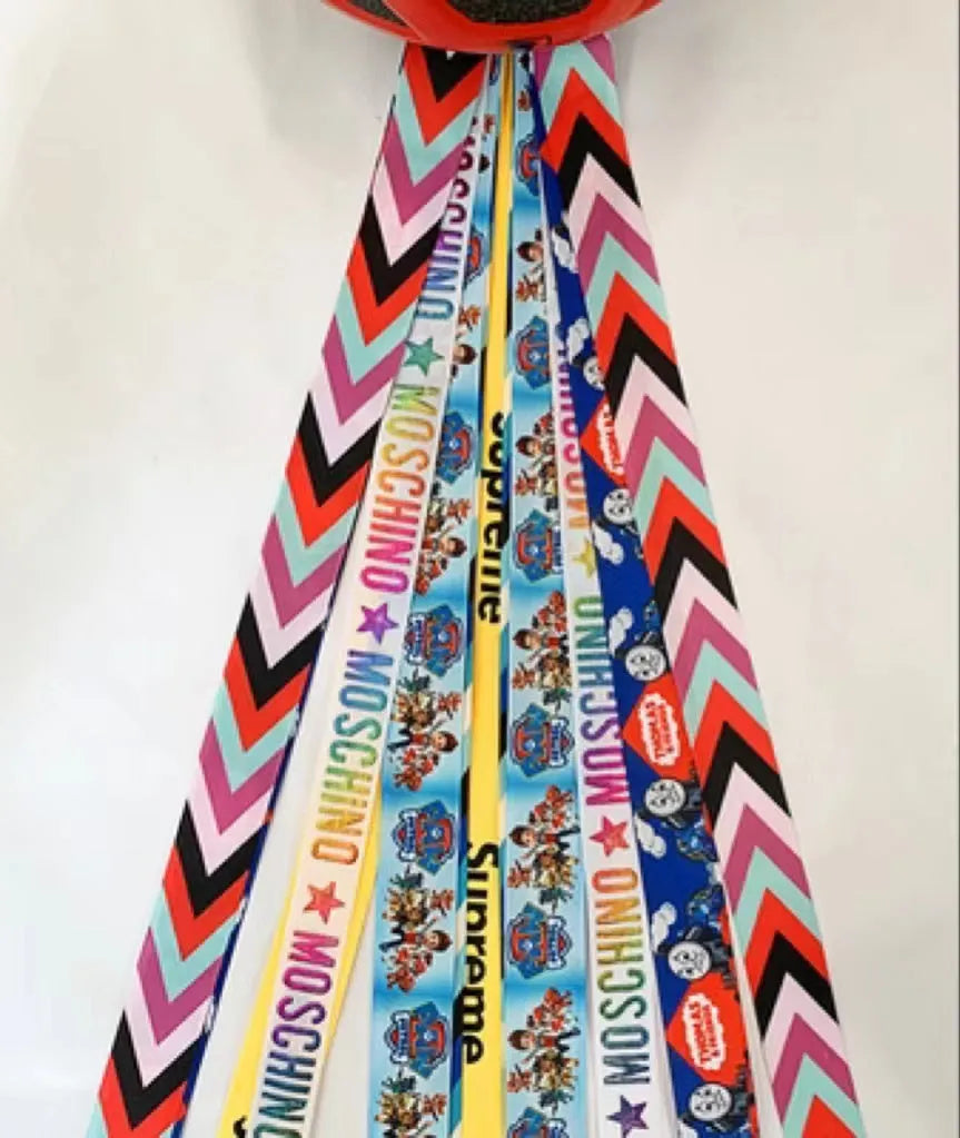 Children's helmet streamer with 60 cm polyester ribbon in colours like apricot and khaki for roller skating and skiing