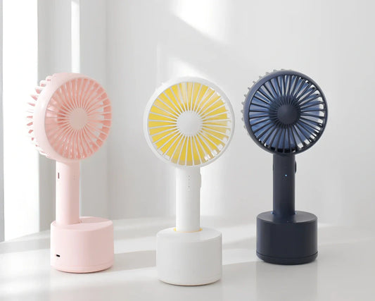 Blue shaking head handheld fan showing oscillating mechanism and USB charging port