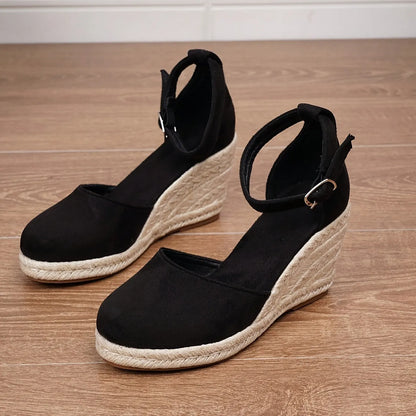 Women's apricot suede Roman style wedge sandals with adjustable buckle on a white background.