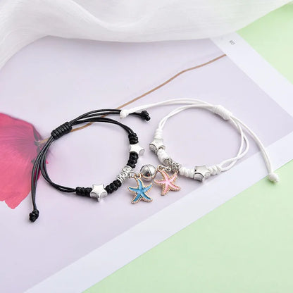 Magnetic suction couple bracelet pair in alloy with an electroplated finish, showing example designs like a crown and love lock.
