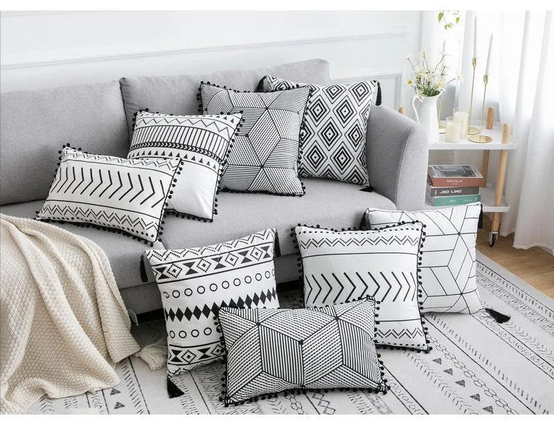 Bohemian style decorative pillowcase in light grey colour on a sofa.