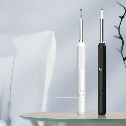 Visual ear cleaning device with camera, ear scoop attachments, and charging cable on white background