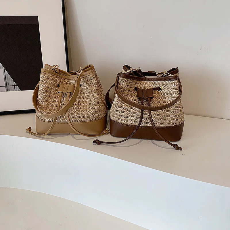 Woven straw women's crossbody bucket bag in brown colour with adjustable strap