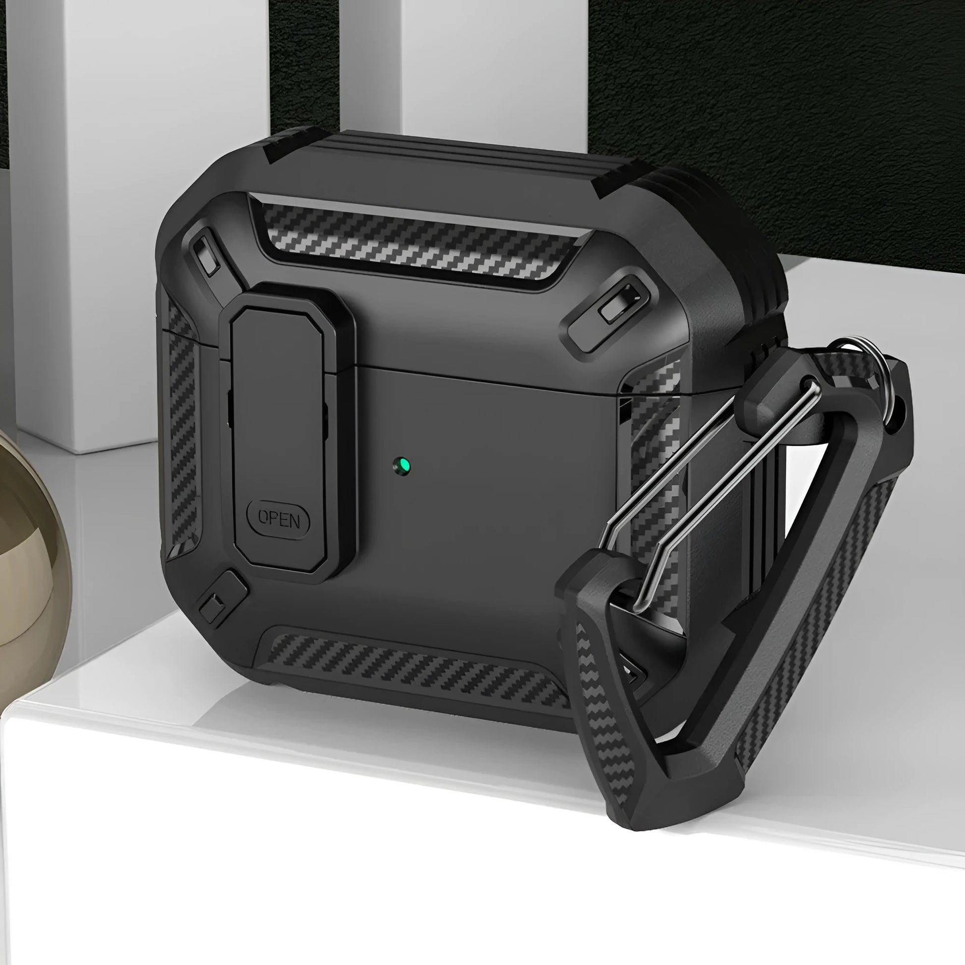 Hard black and yellow plastic clamshell case for AirPods with a silver metal carabiner hook attached.