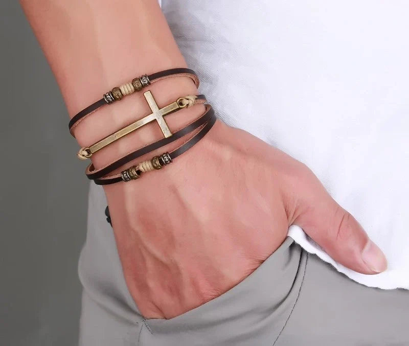 A handcrafted leather bracelet featuring a cross design, perfect for adding a touch of rustic style to any outfit.