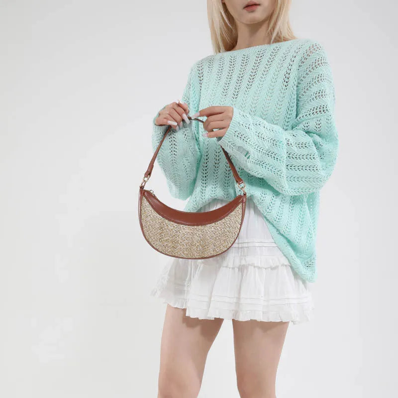 Women's hard-shell straw shoulder bag in a dumpling shape with a crossbody strap, shown in a choice of colours.
