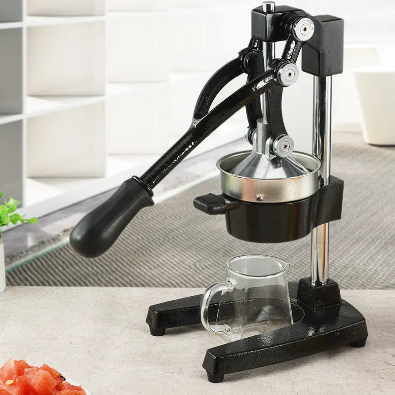 Black manual cast iron juicer with stainless steel strainer, 40cm height, on kitchen counter