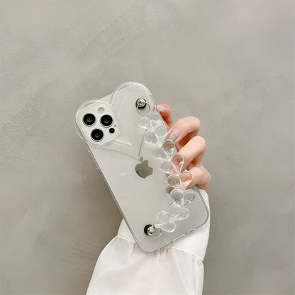 Transparent TPU iPhone case with love bracelet and heart chain design on a table.
