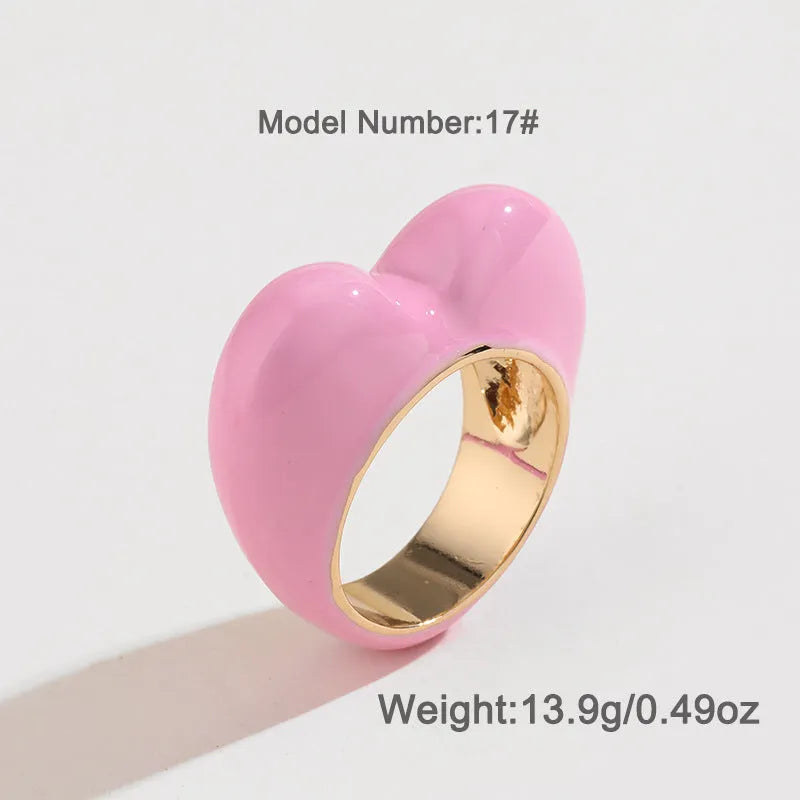 Heart-shaped enamel ring with three-dimensional detail in black, pink, purple, or red, sized for fingers 17-18