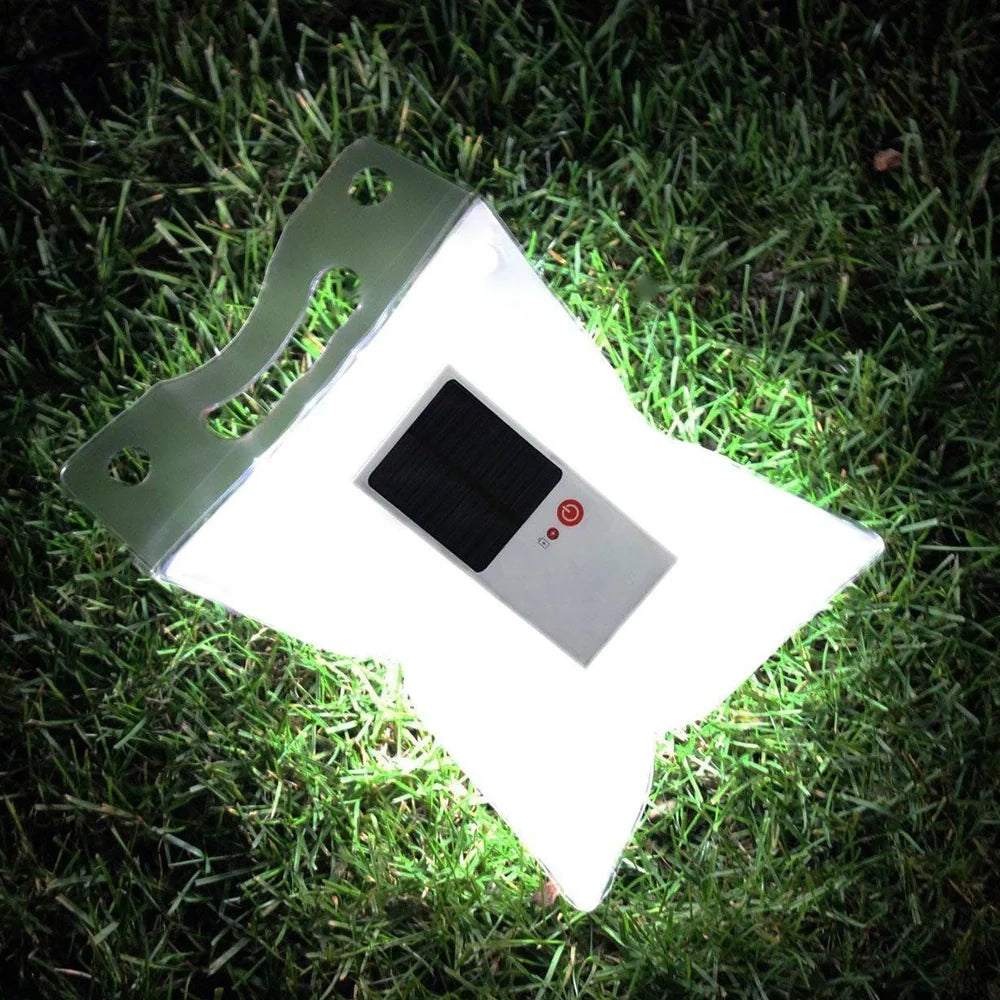 White solar inflatable LED camping light showing 310mm diameter when inflated with integrated solar panel