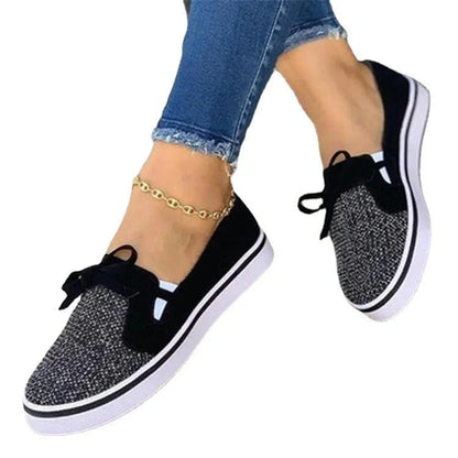 Women's white lace-up canvas flat sneakers with cross straps