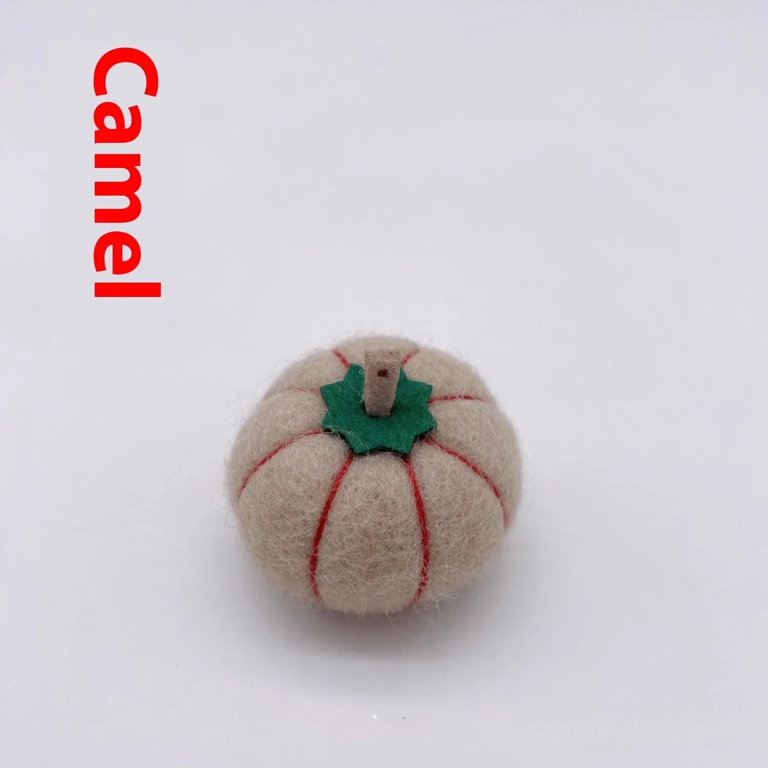 Wool felt pumpkin ornaments in various colours for doll decoration and craft projects.