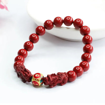 Purple gold sand cinnabar bracelet with carved double Pixiu design, 8mm beads.