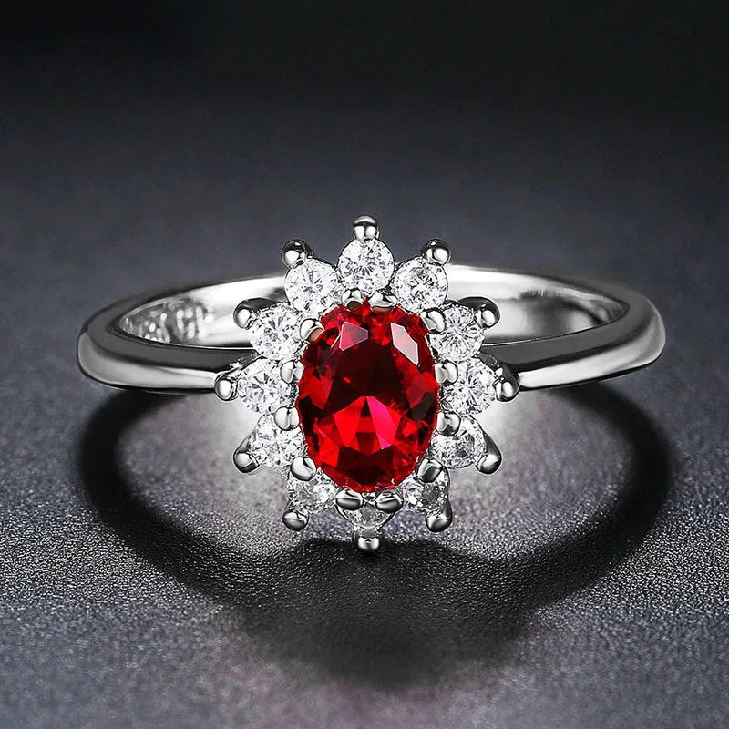 A women's copper ring with a flower design and a central zirconium stone, shown in green, blue, and red colour options.