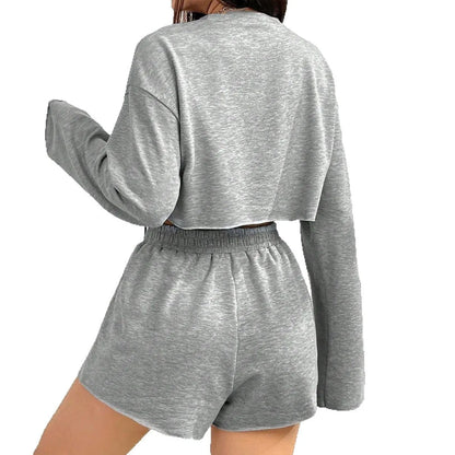 Grey women's long-sleeved T-shirt and shorts polyester set laid flat