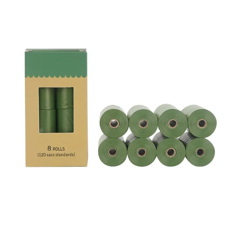 Roll of EPI green degradable pet waste bags next to a transparent dispenser on a grass background.