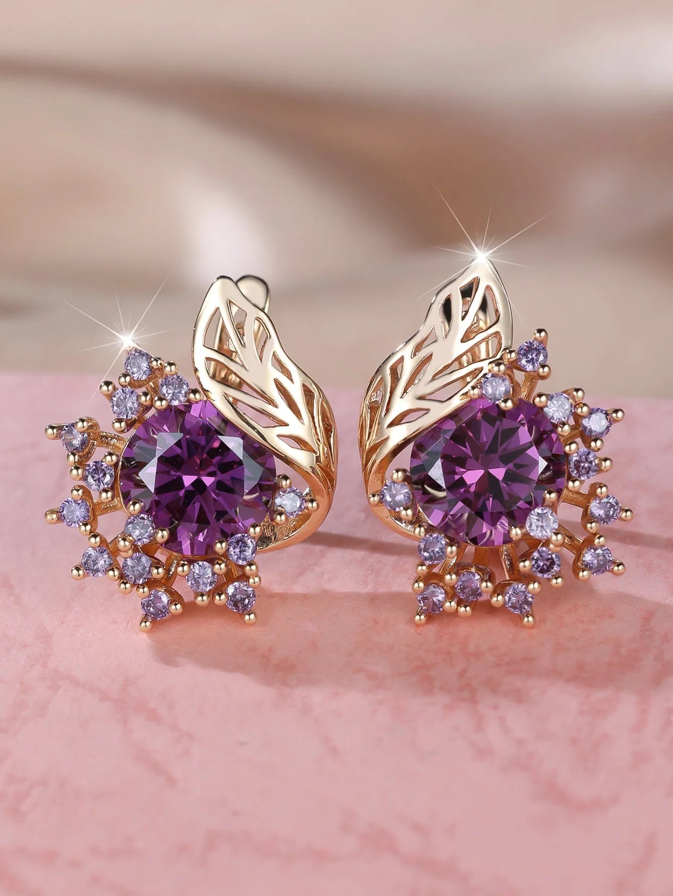 Round flower and feather design earrings in champagne gold with a choice of coloured zircon stones.