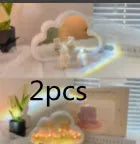 DIY tulip-shaped night lamp kit with LED lights and mirror surface in assorted colours on a desk.