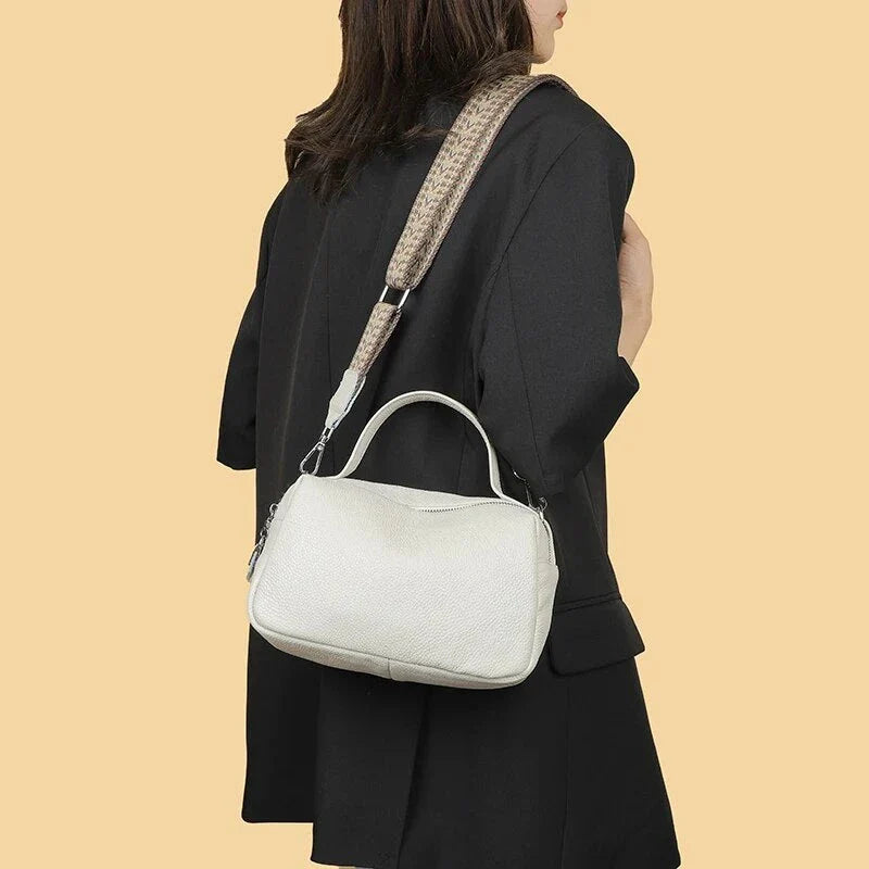 Luxurious genuine leather crossbody bag for women, featuring a soft, compact design with dedicated phone pockets and an adjustable strap for versatile wear.