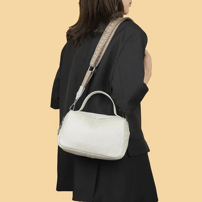 Luxurious genuine leather crossbody bag for women, featuring a soft, compact design with dedicated phone pockets and an adjustable strap for versatile wear.