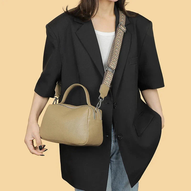 Luxurious genuine leather crossbody bag for women, featuring a soft, compact design with dedicated phone pockets and an adjustable strap for versatile wear.
