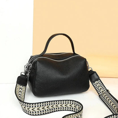 Luxurious genuine leather crossbody bag for women, featuring a soft, compact design with dedicated phone pockets and an adjustable strap for versatile wear.