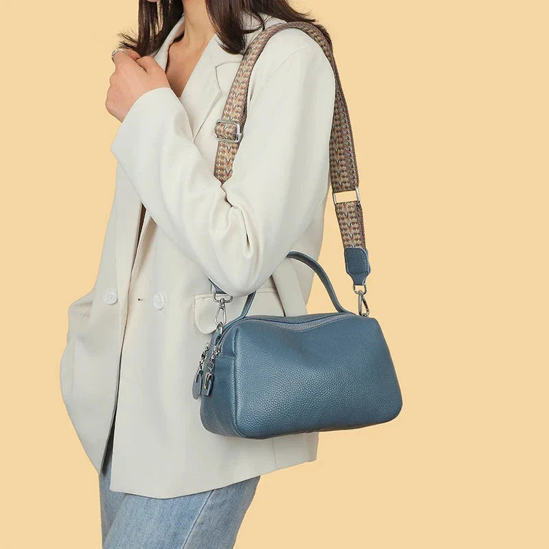 Luxurious genuine leather crossbody bag for women, featuring a soft, compact design with dedicated phone pockets and an adjustable strap for versatile wear.