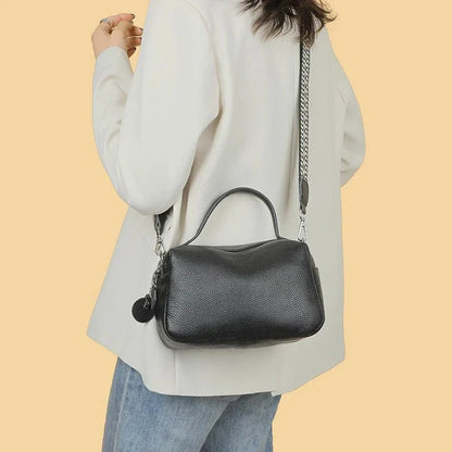 Luxurious genuine leather crossbody bag for women, featuring a soft, compact design with dedicated phone pockets and an adjustable strap for versatile wear.