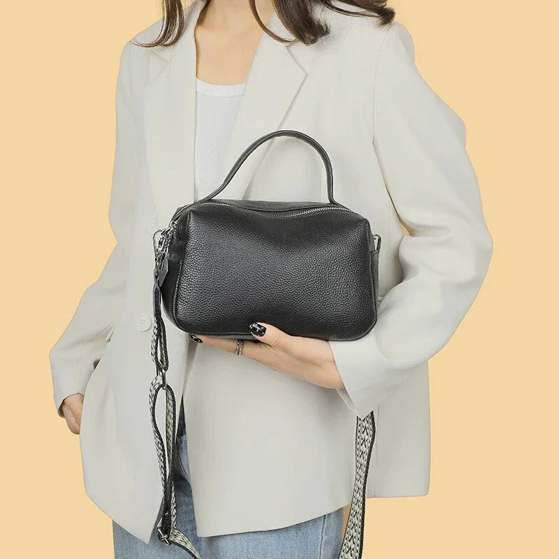 Luxurious genuine leather crossbody bag for women, featuring a soft, compact design with dedicated phone pockets and an adjustable strap for versatile wear.