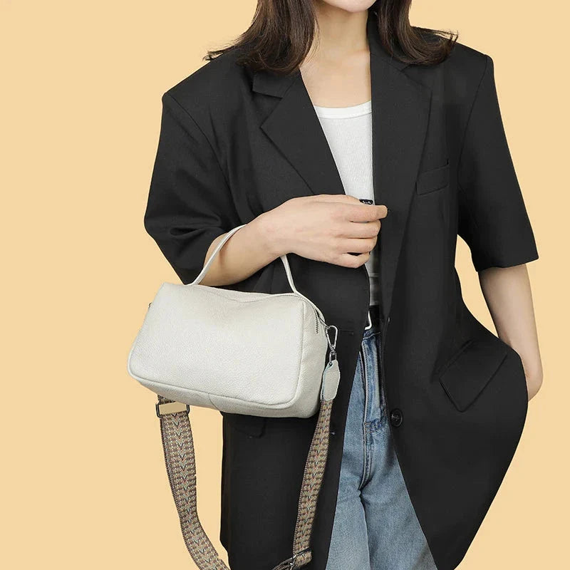 Luxurious genuine leather crossbody bag for women, featuring a soft, compact design with dedicated phone pockets and an adjustable strap for versatile wear.