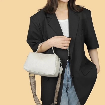 Luxurious genuine leather crossbody bag for women, featuring a soft, compact design with dedicated phone pockets and an adjustable strap for versatile wear.
