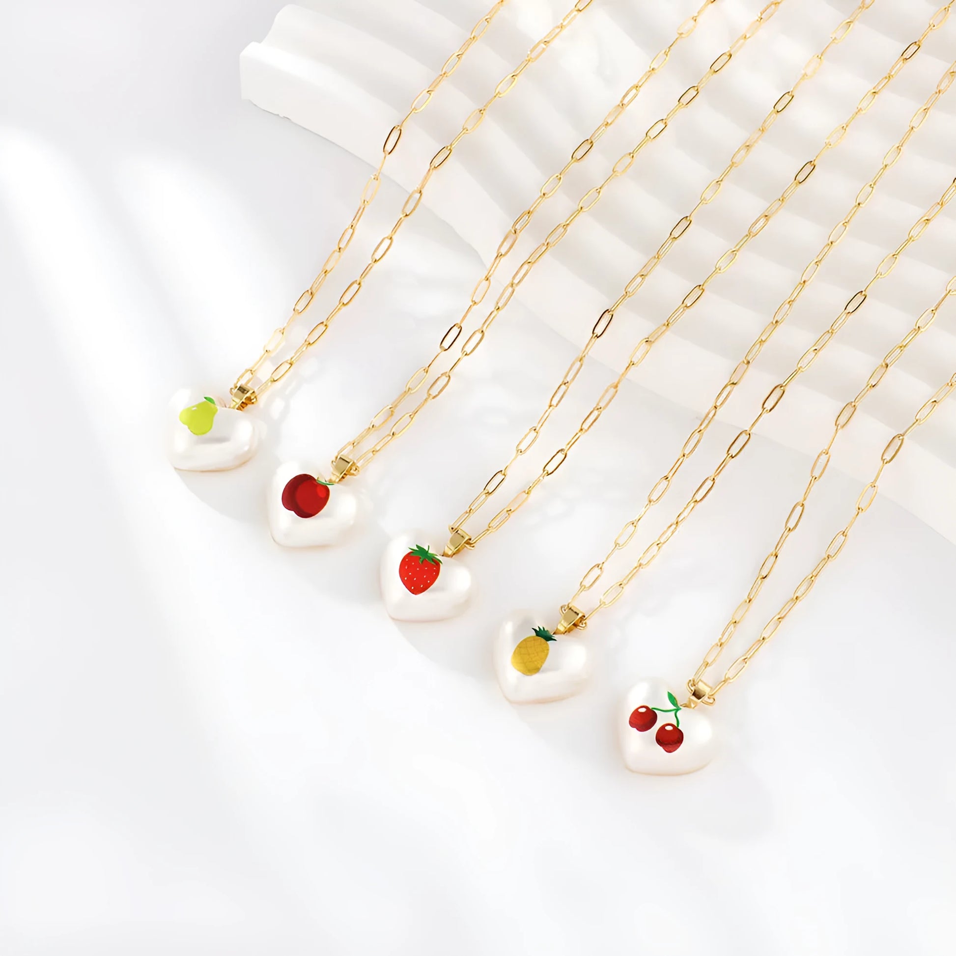 Geometric heart-shaped fruit pendant necklace on an adjustable metal chain