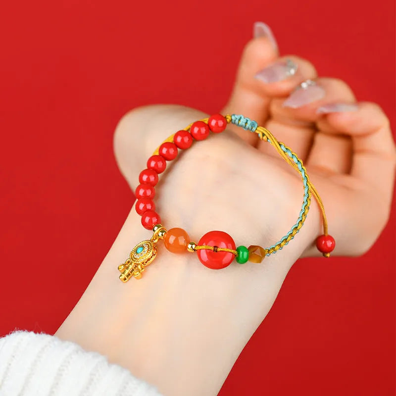 Hand-woven cinnabar peace blessing bracelet in emperor red sand with national style geometry design