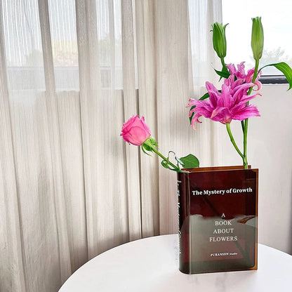 Transparent book-shaped acrylic vase, 22cm long with black font, refracting sunlight for home decor