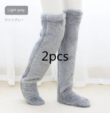 Cozy over-the-knee fuzzy socks in various colors, including brown, blue, dark gray, pink, silver, and more. Comfortable cotton design for warm, snug legs.