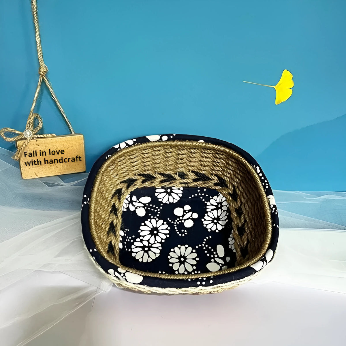 Blue square plastic hand-woven storage basket on a tabletop.