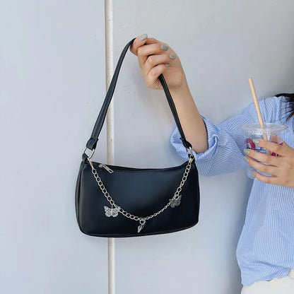 Women's black PU leather chain crossbody bag with butterfly clasp and structured square silhouette