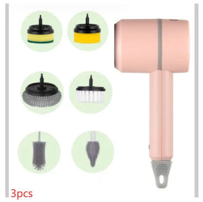 Green electric cleaning brush with scouring pad and brush heads on a kitchen worktop.