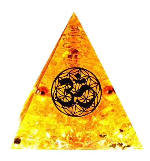 A small 6cm clear epoxy resin pyramid ornament containing pieces of natural crystal gravel on a flat surface.