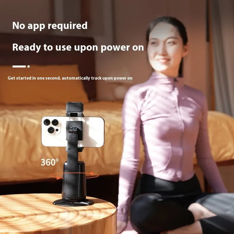 Black desktop phone holder with intelligent face tracking, rotating camera head, and ribbon LED lighting