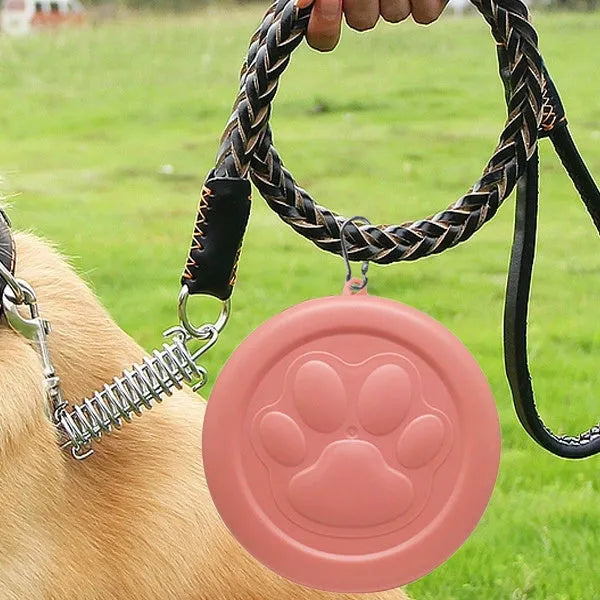 Collapsible silicone dog bowl with integrated snack compartment in light pink colour